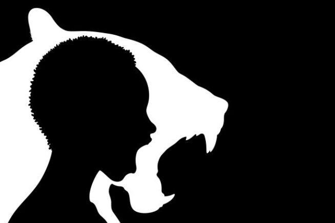 Black and white silhouette image of a person with their mouth open inside a silhouette of a lion roaring