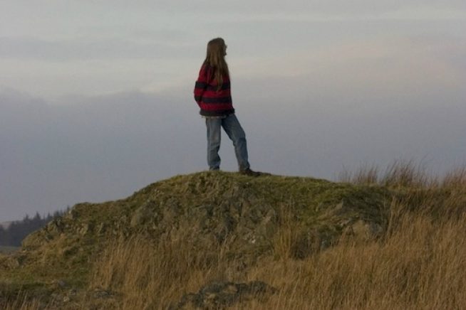 A photo of author Sara Maitland walking in the countryside