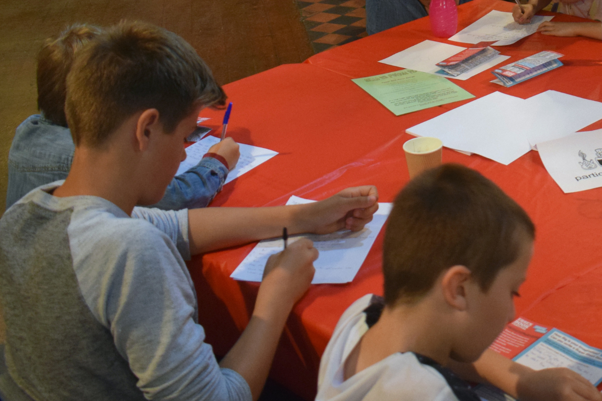 Young people writing at a table